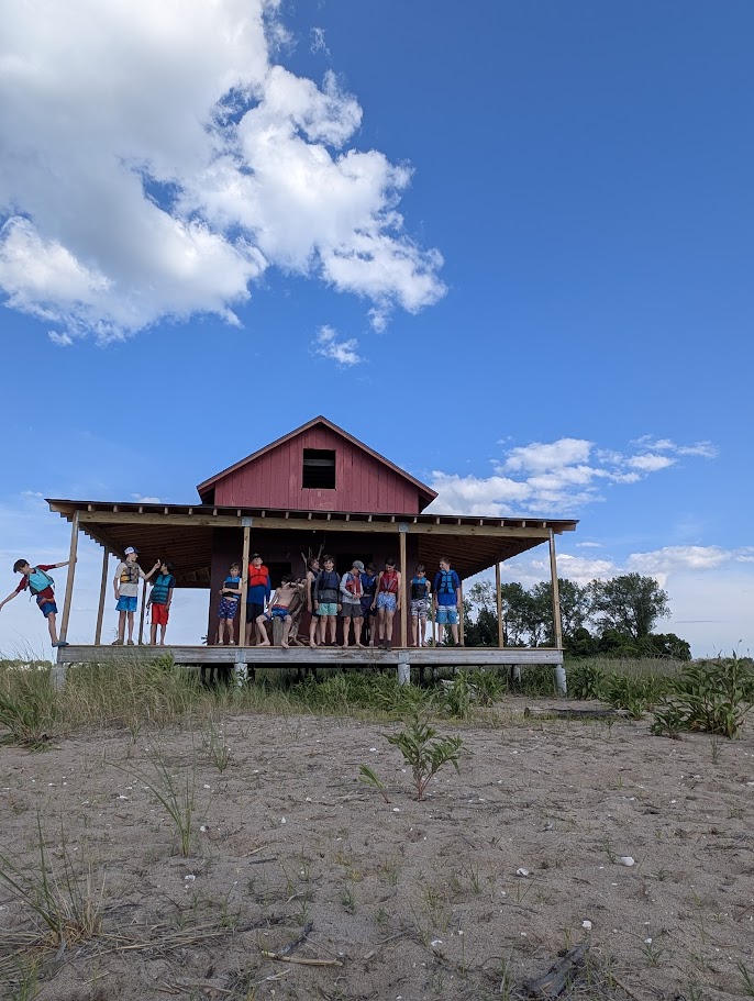 Scouts gathered outside a cabin during the East River trip.